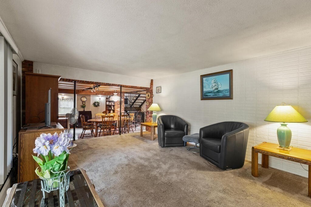 306 Andover Road Billerica, MA 01821 - Photo 8 of 42 a living room with furniture and a flat screen tv