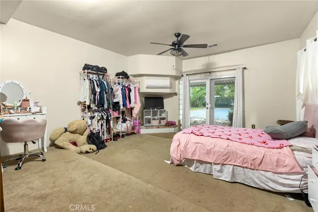 a bedroom with bed and glass windows
