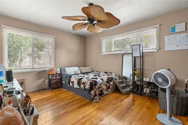 a bedroom with bed and a chandelier