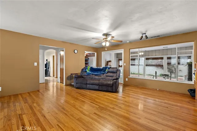 a living room with furniture and wooden floor