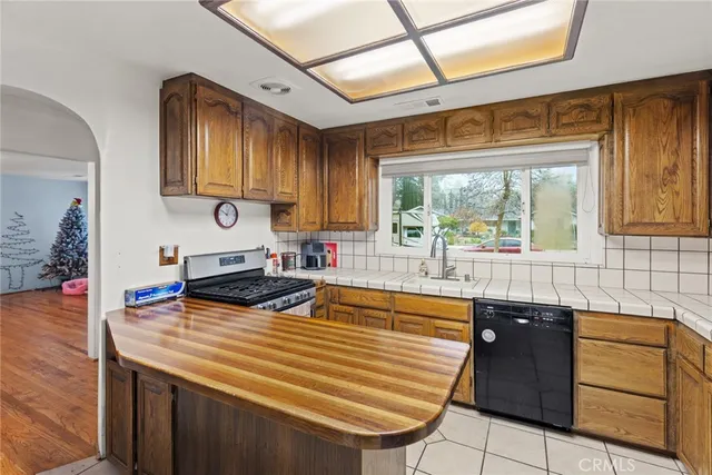 a kitchen with stainless steel appliances granite countertop a sink and cabinets
