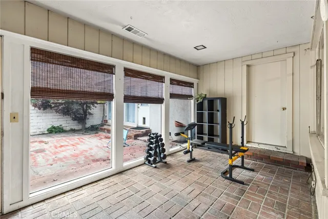 a view of a room with gym equipment and floor to ceiling window