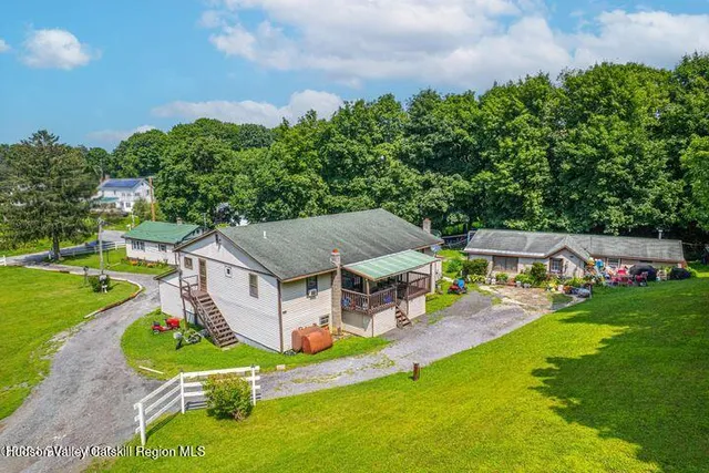 an aerial view of a house with swimming pool garden and patio