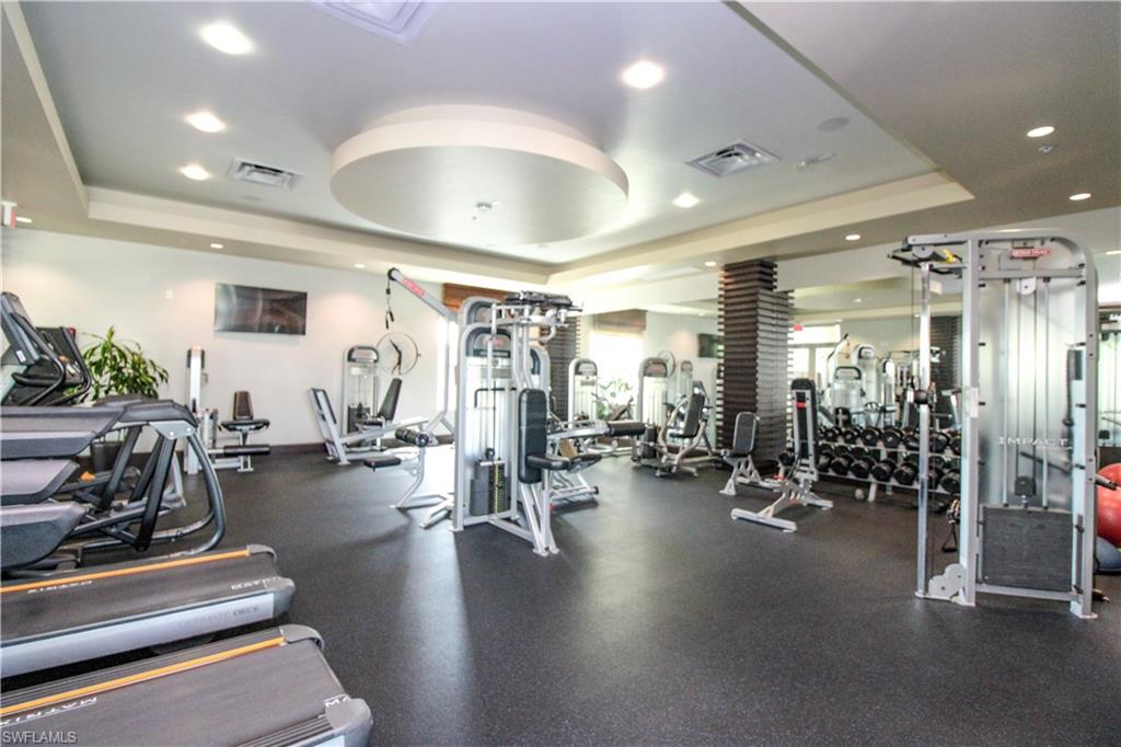 9123 Strada Place, Unit 7410 Naples, FL 34108 - Photo 12 of 50 Exercise room featuring a tray ceiling