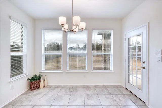 a view of a kitchen with center island and stainless steel appliances