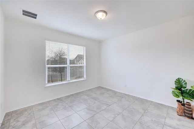 a view of an empty room and a window
