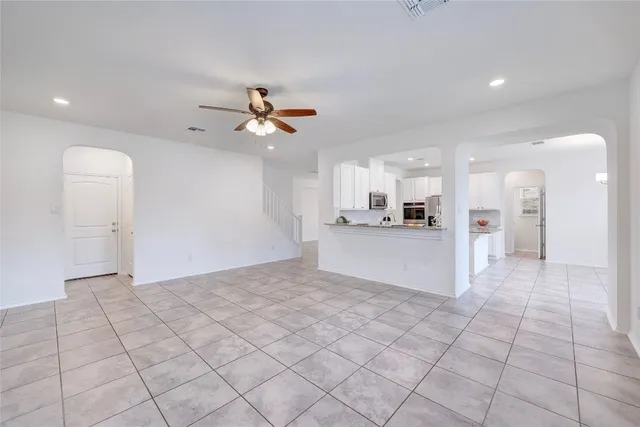 a view of a kitchen with a sink and a refrigerator