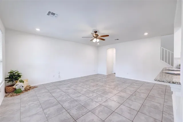 a view of an empty room with window and cabinet