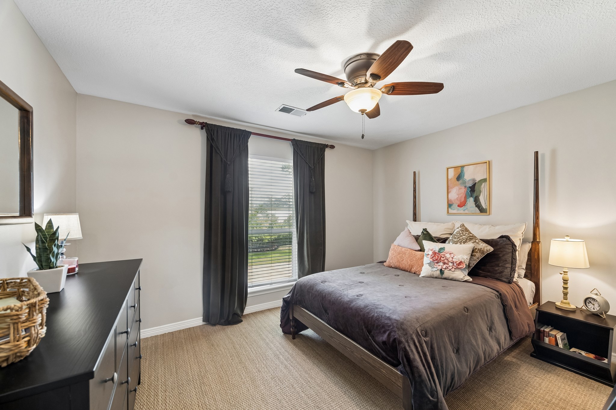 5918 Center Ct Drive Spring, TX 77379 - Photo 20 of 32 a bedroom with a large bed and a chandelier