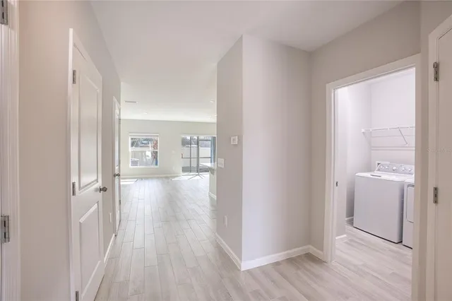 a view of a hallway with wooden floor