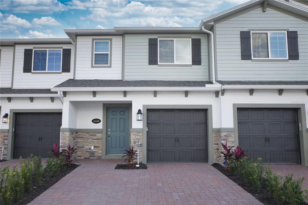 4188 Campsite Loop Orlando, FL 32824 - Photo 2 of 38 a front view of a house with a yard
