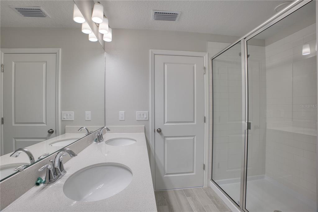 4188 Campsite Loop Orlando, FL 32824 - Photo 21 of 38 a bathroom with a sink and a mirror