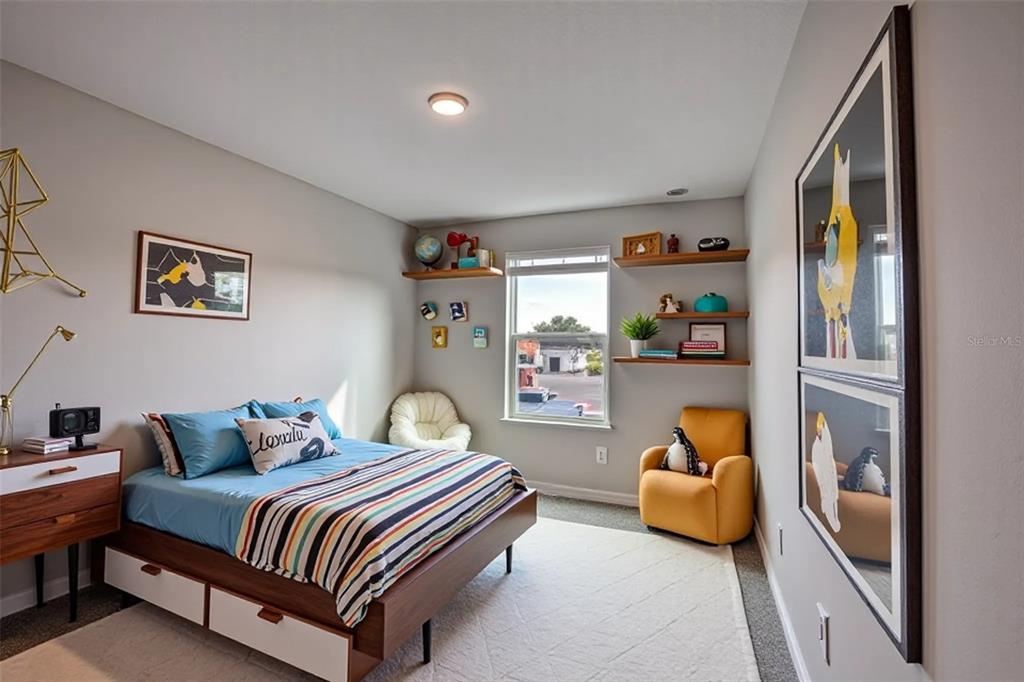 4188 Campsite Loop Orlando, FL 32824 - Photo 23 of 38 a bedroom with a bed and window