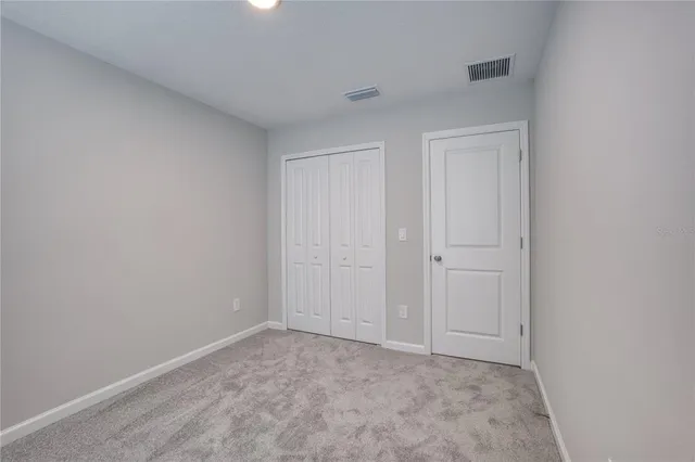 a view of an empty room and entryway