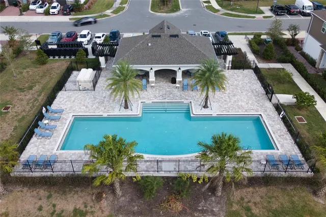 an aerial view of a house with a yard