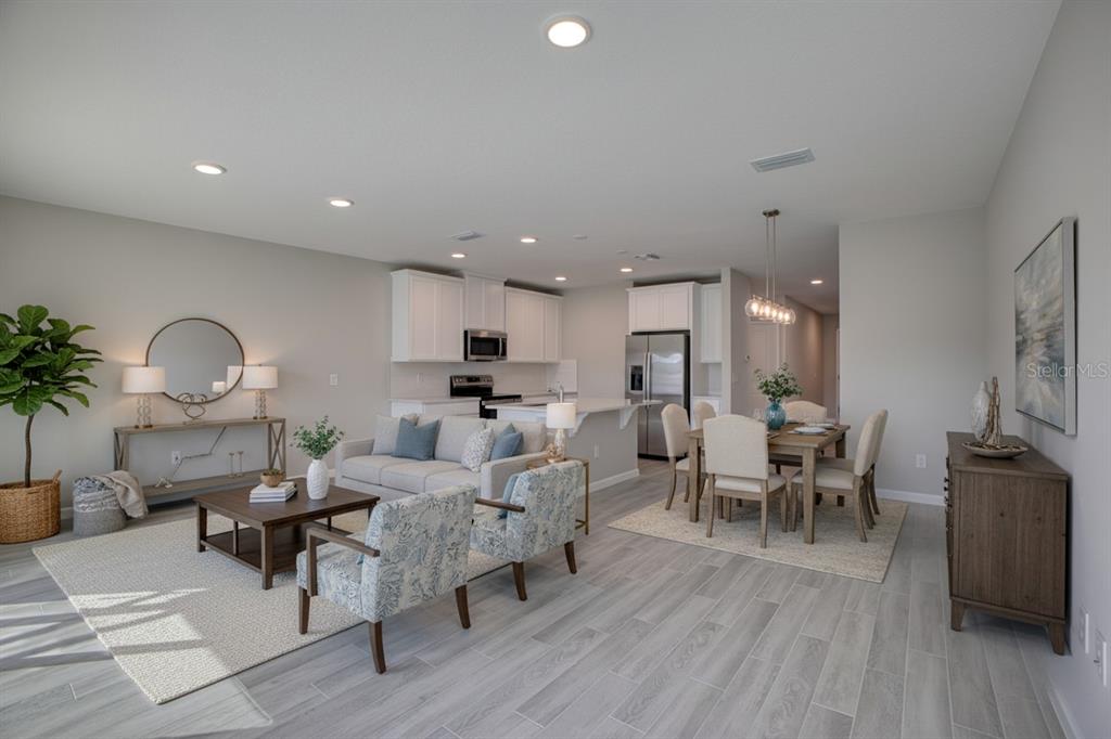 4188 Campsite Loop Orlando, FL 32824 - Photo 7 of 38 a living room with furniture a dining table and a potted plant