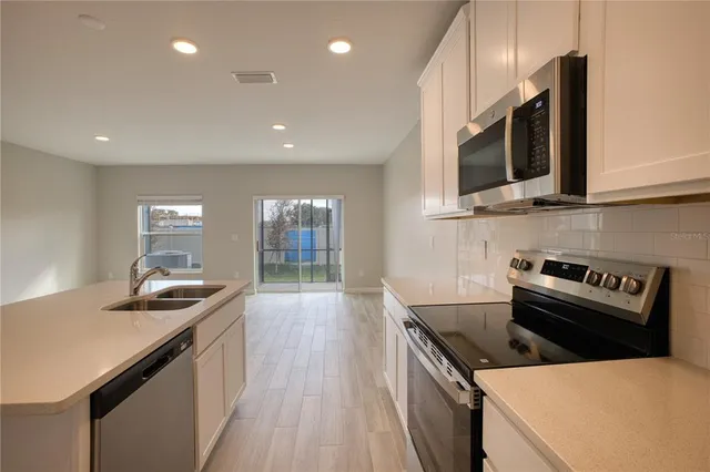 a kitchen with a stove and a microwave
