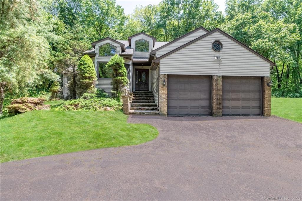 119 Currituck Road Newtown, CT 06470 - Photo 1 of 1 a front view of a house with a yard and garage