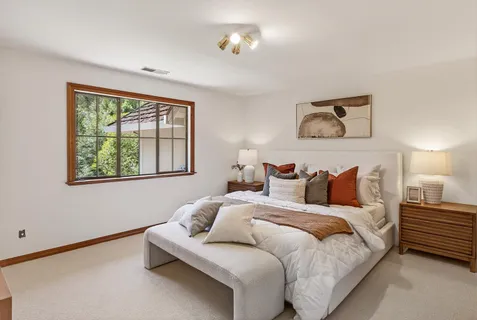 a bedroom with bed and a window
