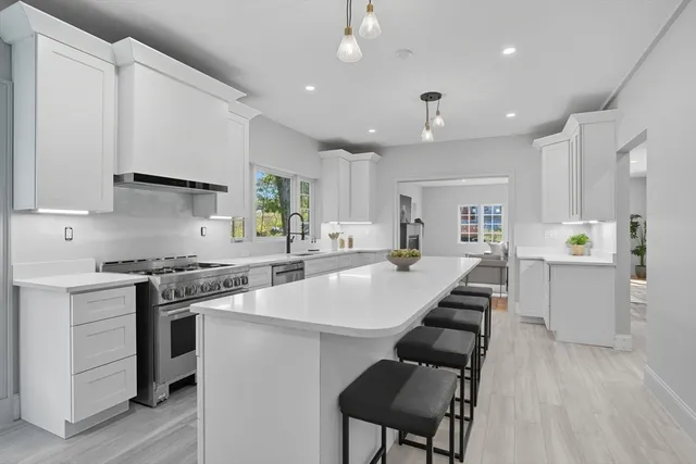 a kitchen with a sink a counter top space and stainless steel appliances