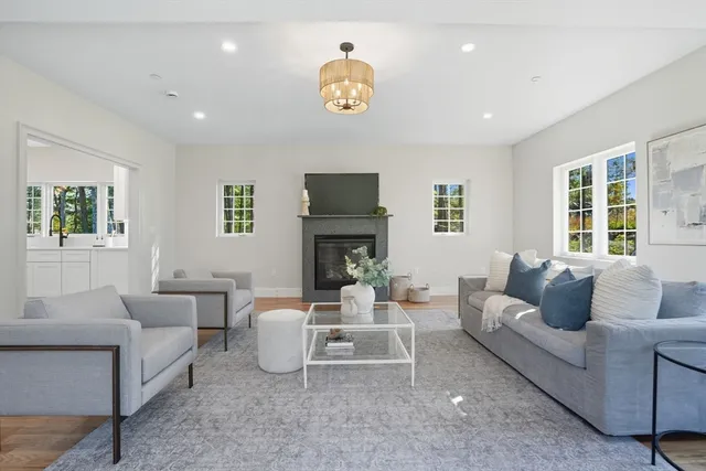 a living room with furniture and a fireplace