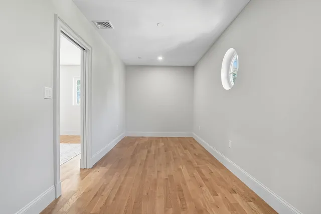 a spacious bathroom with a tub sink shower and mirror