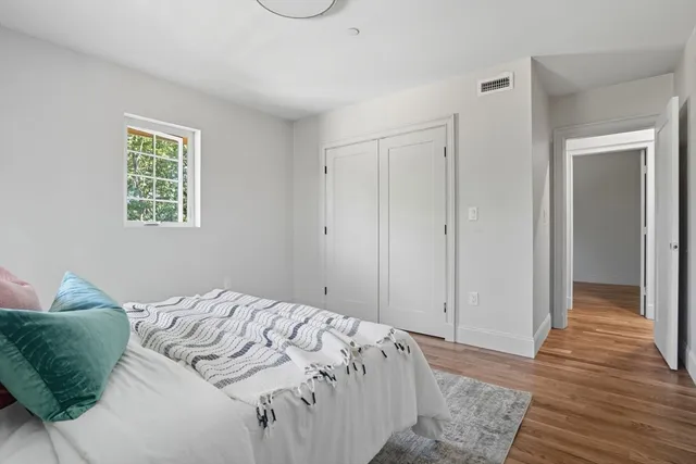 a view of a room with wooden floor and window