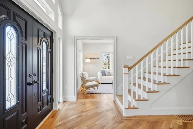 a view of entryway and hall with wooden floor