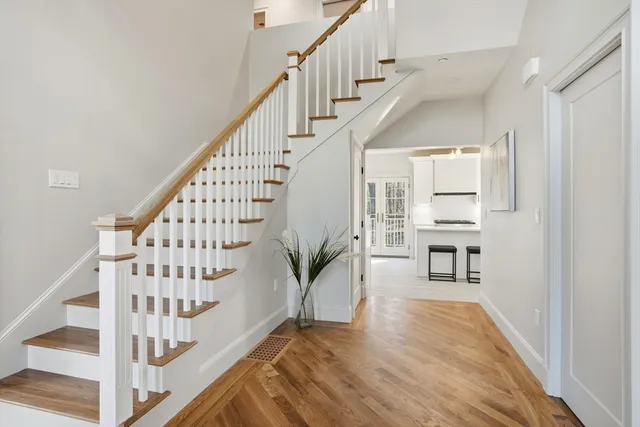 a view of entryway and hall with wooden floor