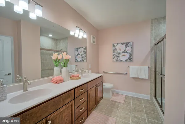a bathroom with a sink a toilet and mirror