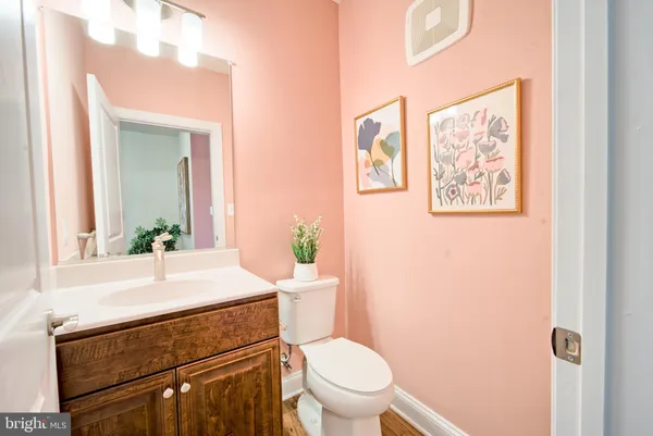 a bathroom with a toilet a sink and a mirror