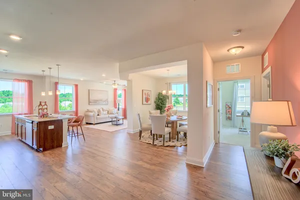 a living room with furniture wooden floor and a large window