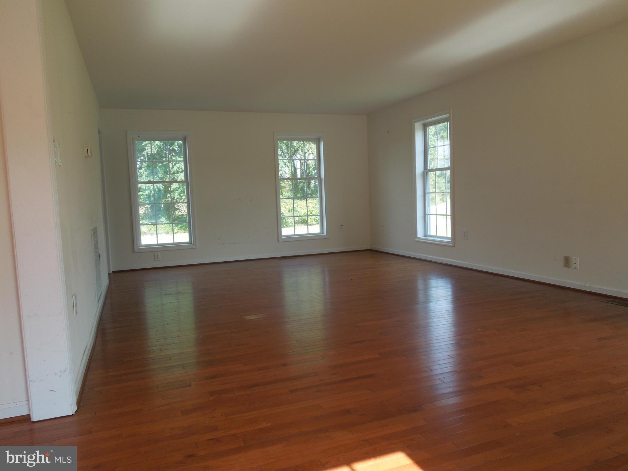 7465 Harmony Road Preston, MD 21655 - Photo 12 of 30 a view of an empty room with wooden floor and window