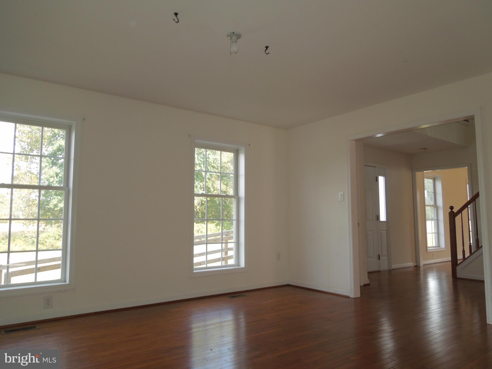 7465 Harmony Road Preston, MD 21655 - Photo 14 of 30 a view of an empty room with wooden floor and a window