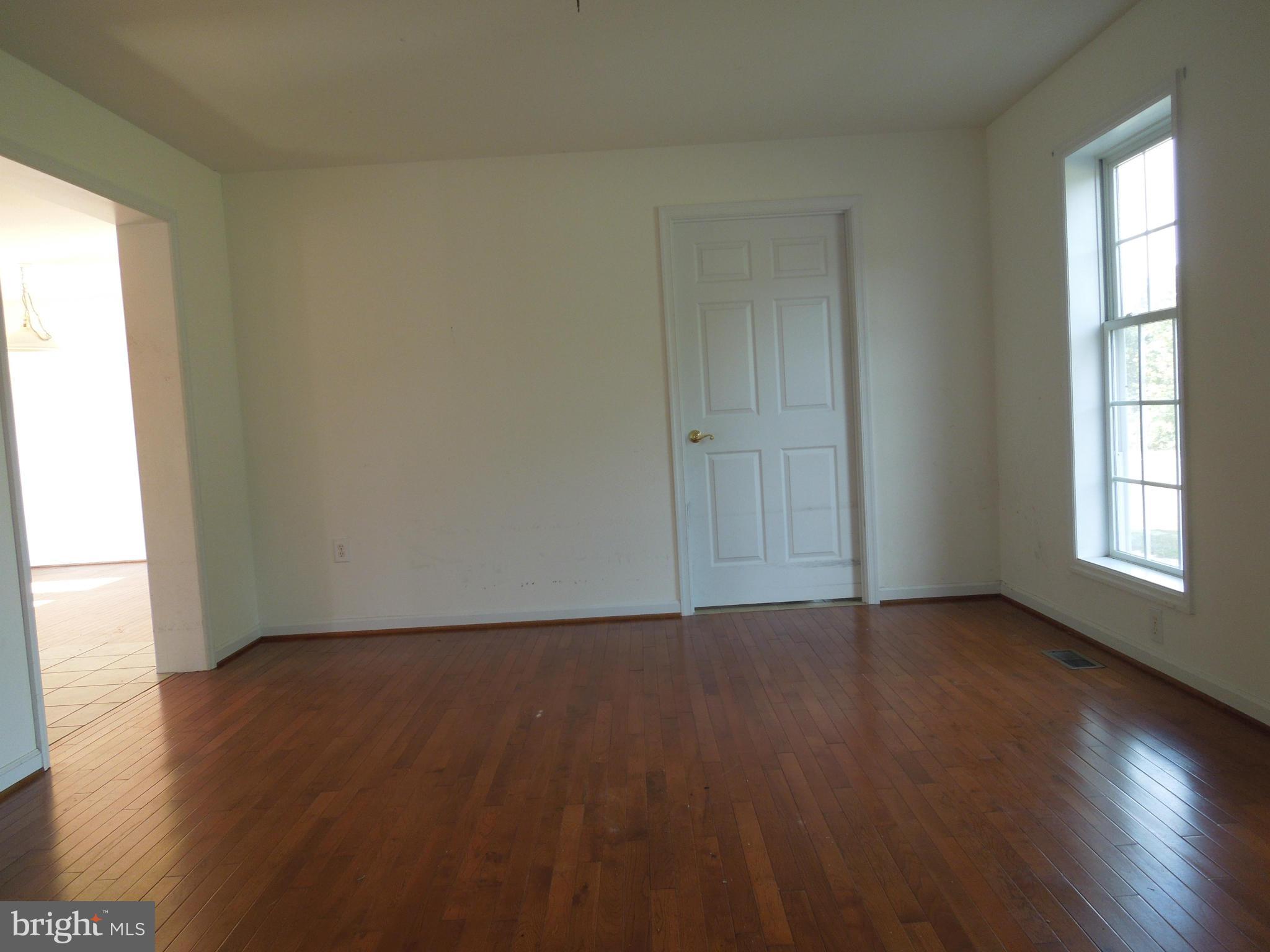 7465 Harmony Road Preston, MD 21655 - Photo 15 of 30 a view of an empty room with wooden floor and a window