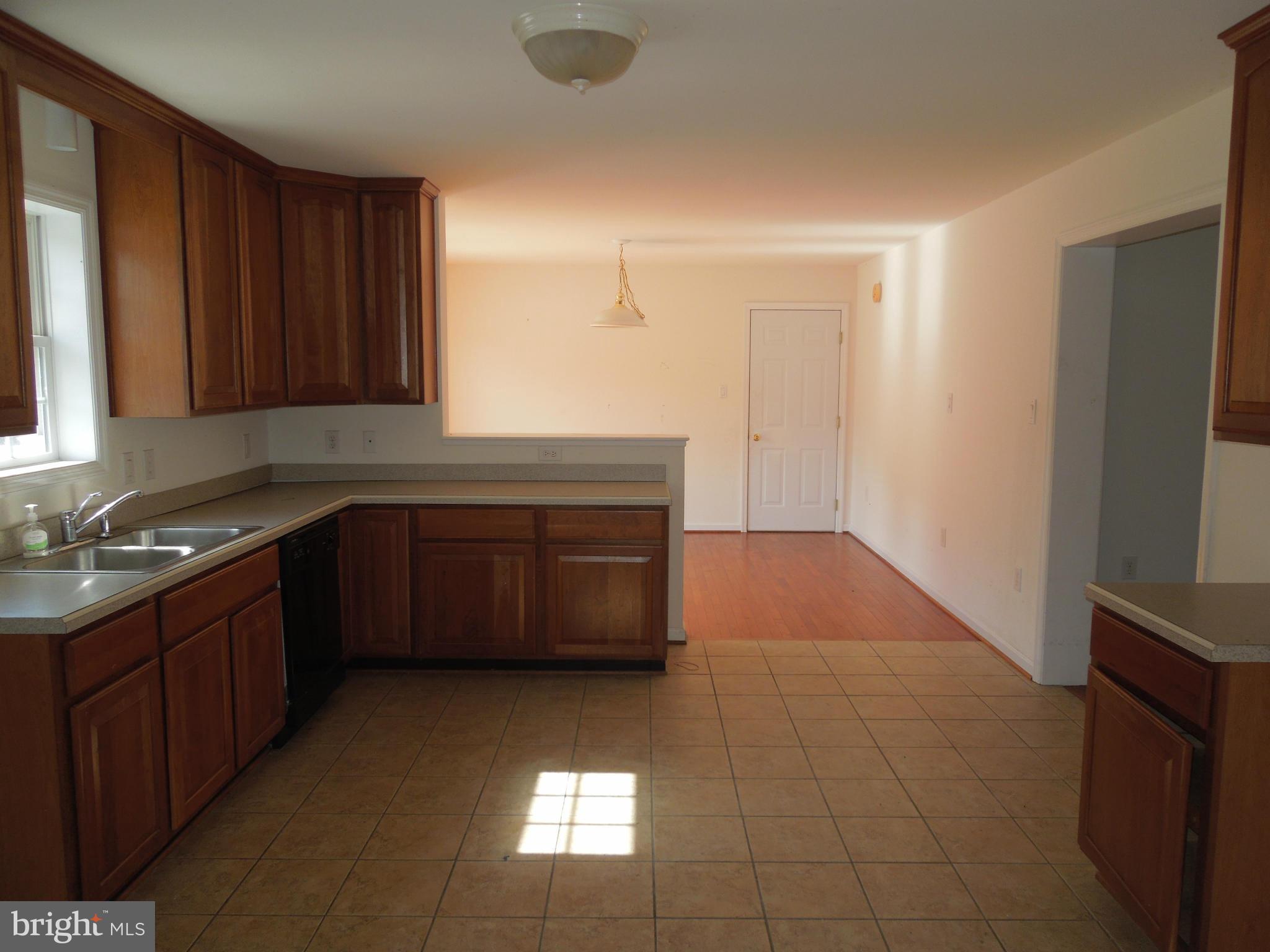 7465 Harmony Road Preston, MD 21655 - Photo 7 of 30 a kitchen with a sink a stove and a microwave