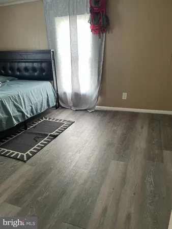 a view of a room with wooden floor and window