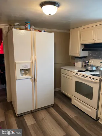 a white refrigerator freezer sitting inside of a kitchen