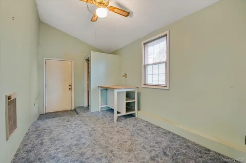 an empty room with windows and cabinet