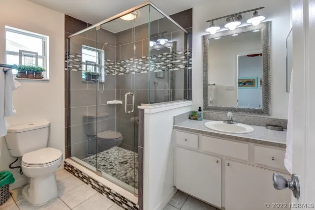 a bedroom with a bed a window and wall painting