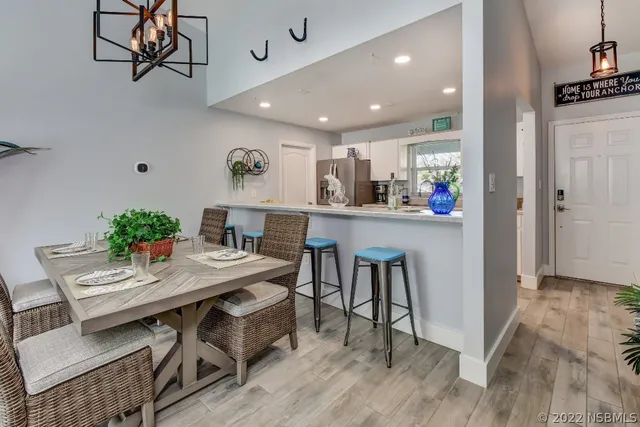 a living room with furniture a chandelier and a flat screen tv