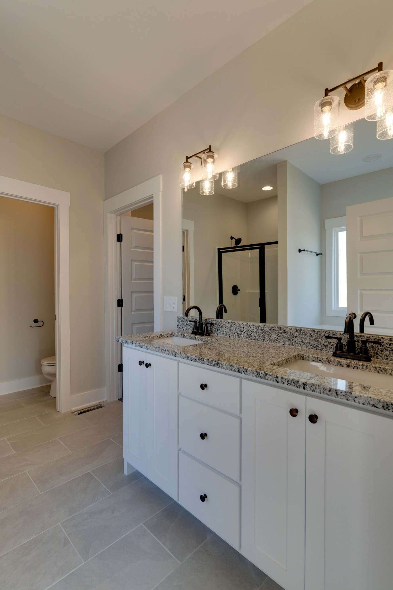155 Julia Ann Court Springfield, TN 37172 - Photo 9 of 17 a bathroom with a granite countertop sink a mirror and a shower