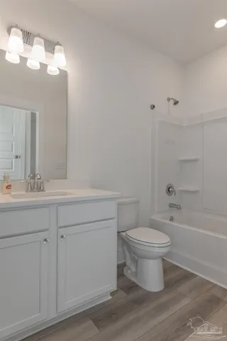 a bathroom with a sink toilet a mirror and shower