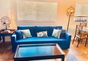 3206 West Azeele Street, Unit 220 Tampa, FL 33609 - Photo 2 of 9 a view of table and chair in wooden floor