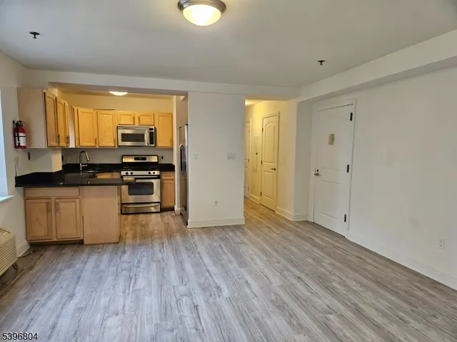 a kitchen with wooden floors and white appliances