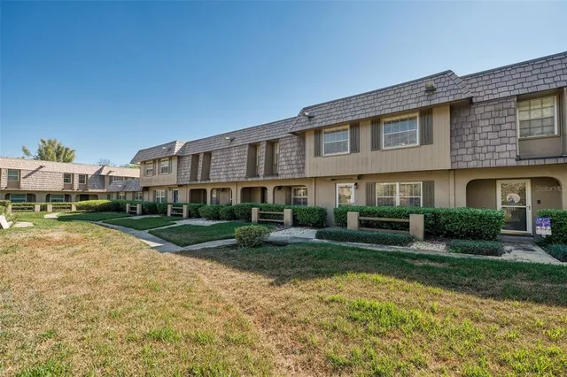 a front view of a house with a yard porch and outdoor seating