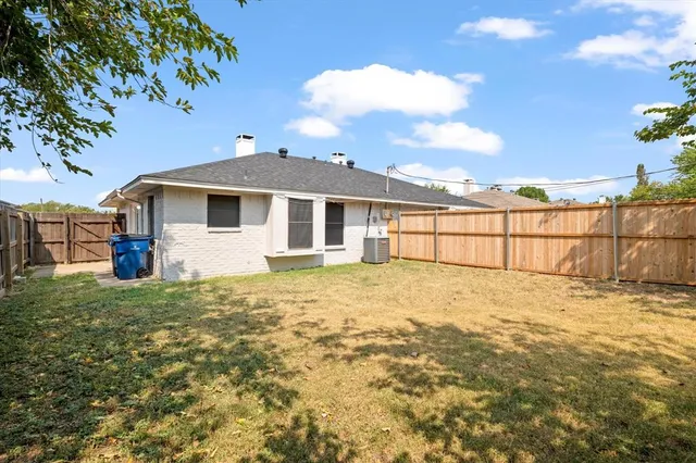 a view of a yard in front of a house with a garden