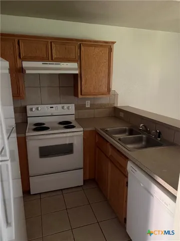 a kitchen with a stove and a sink