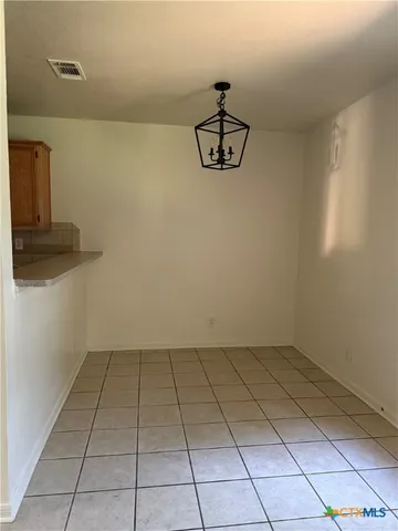 a bathroom with a granite countertop sink a toilet and a mirror