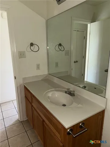 a view of staircase with wooden floor and white walls